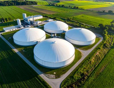 Modern Biogas Storage Tanks in Agricultural Facility Surrounded by Green Fields